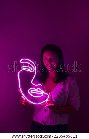 Beautiful girl with neon signs. Pink neon sign face. Trendy style.  Neon sign. Custom neon. Home and salon decor.