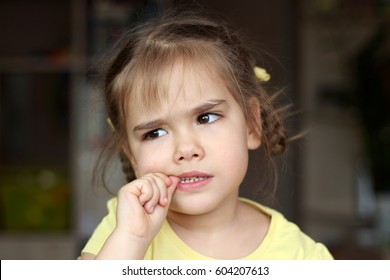 Beautiful Girl Nervously Biting Her Nails, Childhood And Family Concept, Emotional Child Portrait, Indoor Closeup