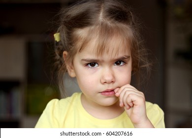 Beautiful Girl Nervously Biting Her Nails, Childhood And Family Concept, Emotional Child Portrait, Indoor Closeup