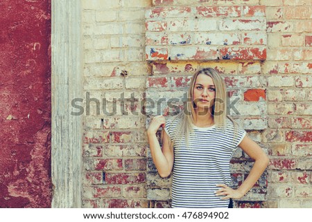 beautiful girl on a background of a brick wall