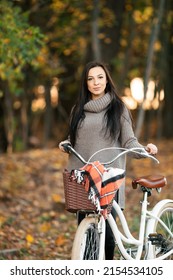 Beautiful Girl On A Bike In The Autumn Forest