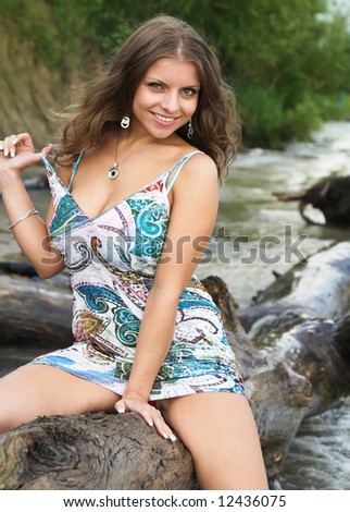 The beautiful girl on a coast of the river