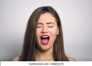 Beautiful Girl With Open Her Mouth In A Yellow Dress, Closeup Isolated On White Background