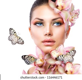 Beautiful Girl With Orchid Flowers and Butterfly. Beauty Face