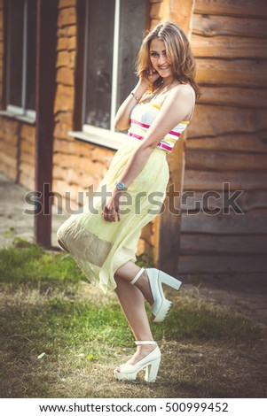 Woman in front of a yellow beach house