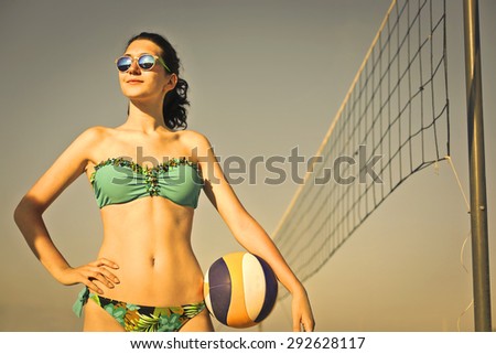 Beautiful girl playing beach volley