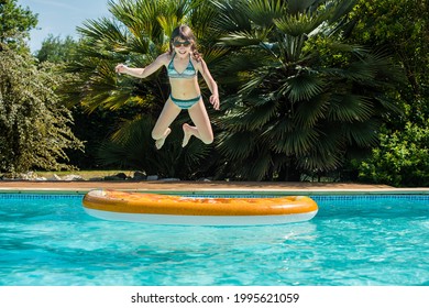 beautiful girl playing in the pool with her inflatable mattress - Powered by Shutterstock