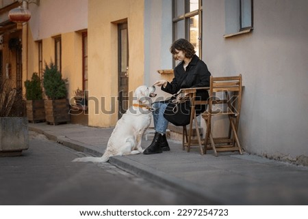 Similar – Portrait of a young, tall woman behind a blond Labrador