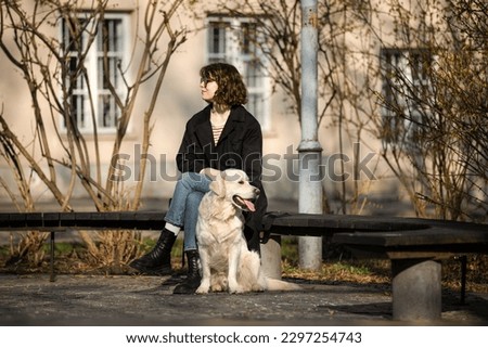 Similar – Portrait of a young, tall woman behind a blond Labrador