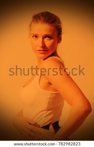 Similar – Close up front upper body portrait of one young athletic woman in sportswear in gym over dark background, looking at camera