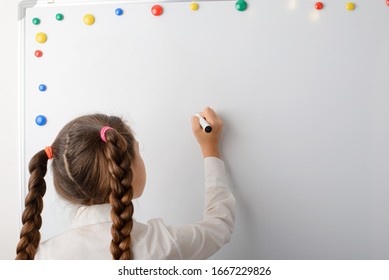 Beautiful girl pupil of secondary school writing something on the board - Powered by Shutterstock