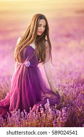 Beautiful Girl In Purple Dress In Lavender Field