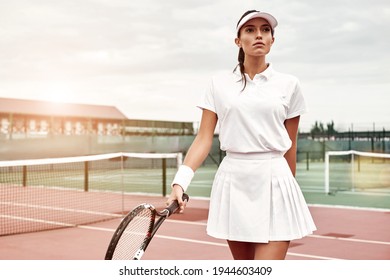 Beautiful girl with a racket on a court - Powered by Shutterstock