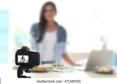 Beautiful Girl Recording Video On Camera At Kitchen. Food Blogger Concept