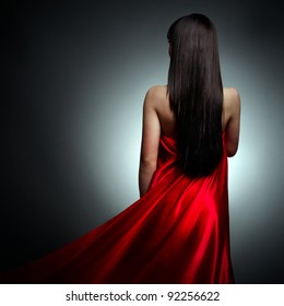 Beautiful Girl In Red Dress Back On Black Background