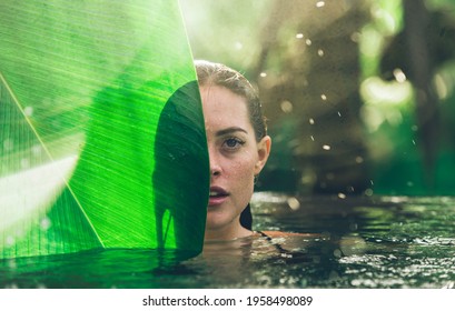 Beautiful girl relaxing outdoor in her garden with swimming pool. Summer concept about lifestyle,beauty, vacations and real estates