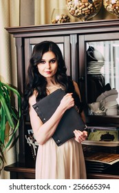 Beautiful Girl In A Restaurant Hostess Posing At The Camera .