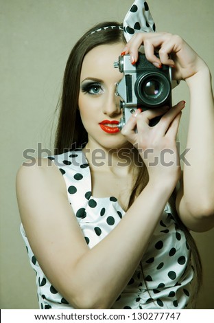 beautiful girl in retro style with a camera