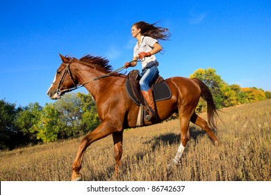 Beautiful girl riding a horse  in countryside.