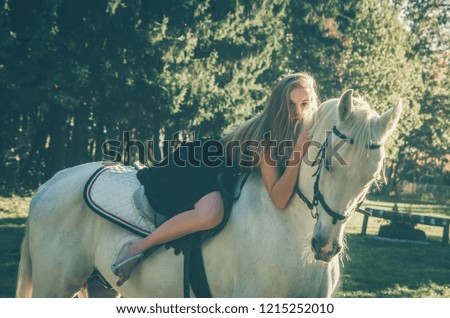 
beautiful girl riding a horse in a long dress