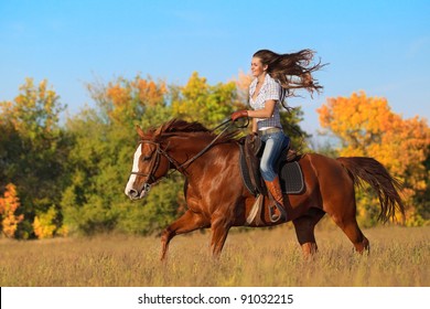 Beautiful girl  riding a horse on autumn field