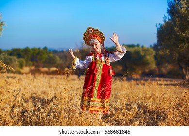 Beautiful Girl In Russian Folk Costume Dancing At Field