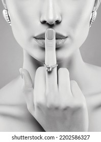 beautiful girl showing finger with wedding ring. young woman face part with jewels accessories. Beauty Fashion Black and white portrait - Shutterstock ID 2202586327