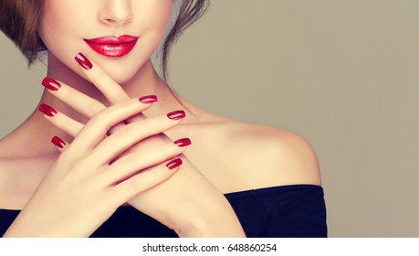 Beautiful Girl Showing Red  Manicure Nails . Makeup And Cosmetics