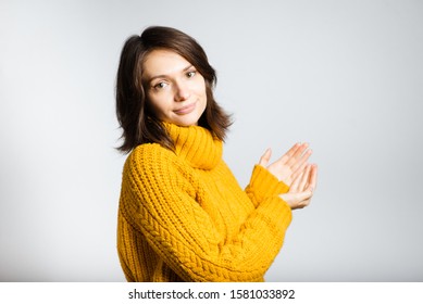 beautiful girl shows something on a hand isolated on white background