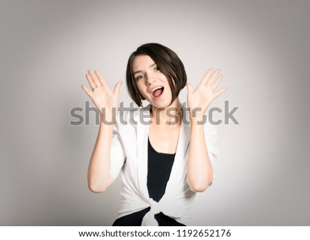 beautiful girl shows a surprise, short haircut, isolated over the background