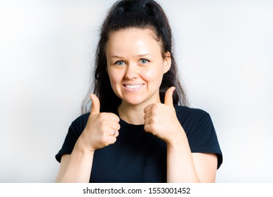 beautiful girl shows thumbs up isolated on white background - Shutterstock ID 1553001452