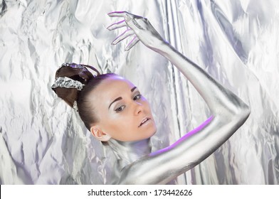 Beautiful girl with silver body art and cold make up stands against the silver background - Shutterstock ID 173442626