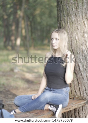 Beautiful girl sitting in the forest