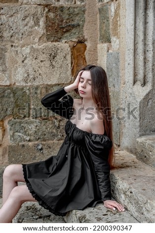 Similar – Portrait of a girl in red dress on a wooden door