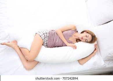 Beautiful Girl Sleeping With Body Pillow In Bedroom