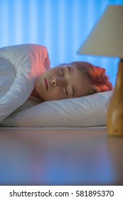 The Beautiful Girl Sleeping On The Bed. Evening Night Time