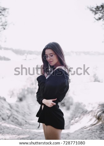 beautiful girl, spectacled on a lake. Around the forest, red tints. Portrait of girl on a lake. Rest.