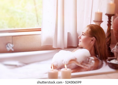 Beautiful Girl Spending Time In The Spa Hotel, Relaxing In The Nice Bath With Foam, Looking In The Window, Healthy Treatment And Enjoyment