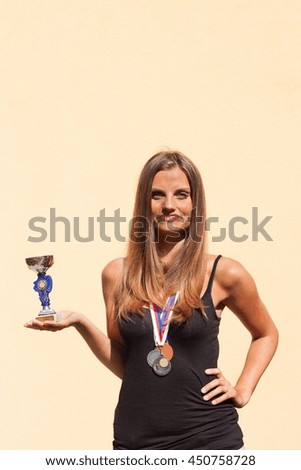 Beautiful girl and sports medals. Sports champion. Awards for sporting achievements.