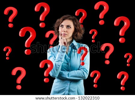 Beautiful girl standing among many red questions