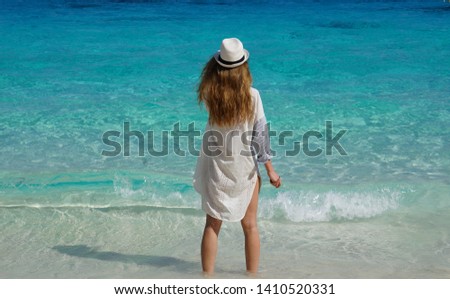 Beautiful girl standing and looking at the Andaman sea