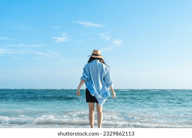 beautiful girl standing on the beach - Shutterstock ID 2329862113