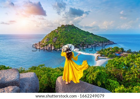 Beautiful girl standing on viewpoint at Koh Nangyuan island near Koh Tao island, Surat Thani in Thailand.