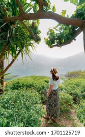 A Beautiful Girl Stands In Greenery, Looks At The Landscape On The Island Of Crete In Greece, Lake Kournas