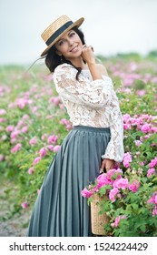 Beautiful Girl In Straw Hat Collect Roses In Bulgaria In Sunrise. Series.