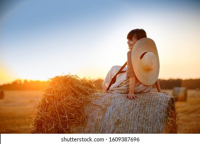 
beautiful girl in the summer hay, sunset - Shutterstock ID 1609387696