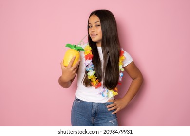 Beautiful Girl In Summer Outfit Drinking Pinapple Juice Isolated On Pink Background.