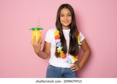 Beautiful Girl In Summer Outfit Holding Pinapple Juice Isolated On Pink Background.