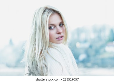 Beautiful girl in sweater freezing outdoor