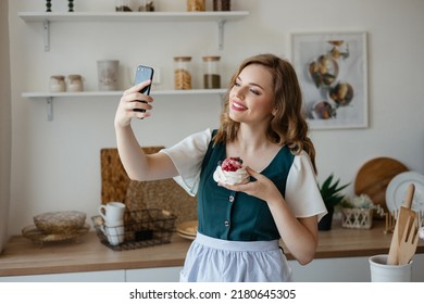 Beautiful girl takes a selfie with a cake in the kitchen - Powered by Shutterstock